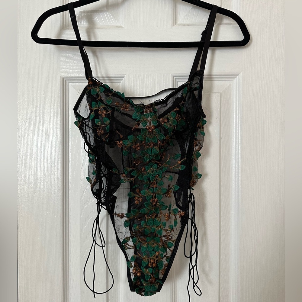 Black bodysuit with green and gold details